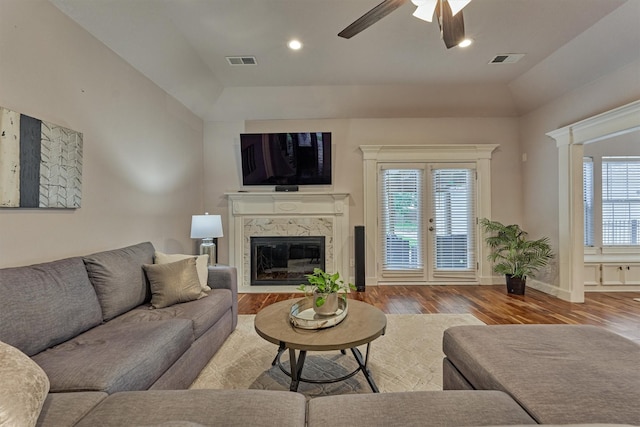 living room with wood finished floors, a fireplace, a ceiling fan, baseboards, and recessed lighting