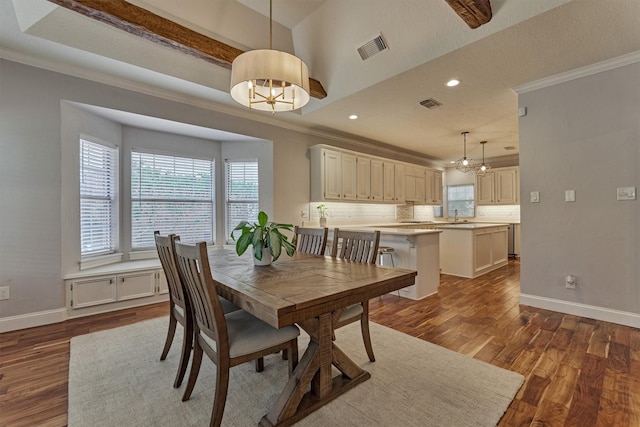 dining room with a chandelier, plenty of natural light, ornamental molding, dark wood finished floors, and baseboards