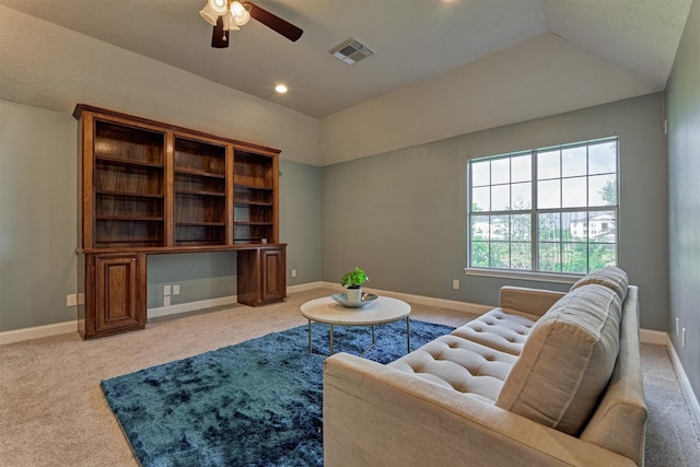 living room with a ceiling fan, light carpet, lofted ceiling, and baseboards