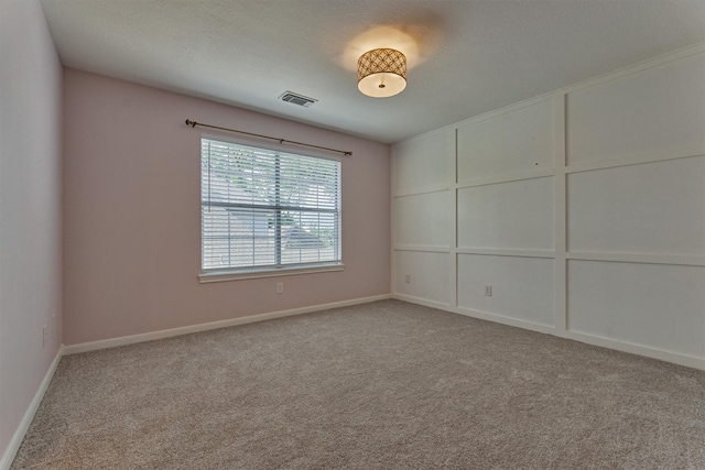 unfurnished room featuring carpet flooring and baseboards