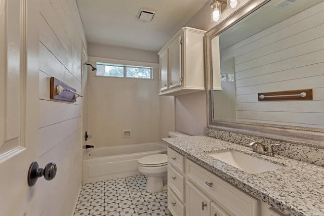 bathroom featuring toilet, bathtub / shower combination, tile patterned floors, and vanity