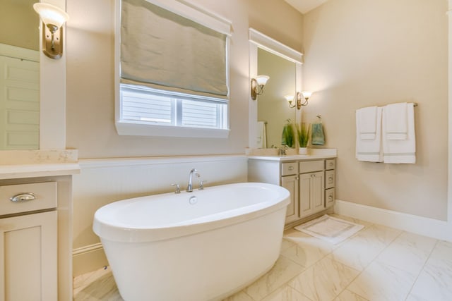 2176 Rope Maker Rd, Conroe, TX 77384 - bathroom featuring vanity, a freestanding bath, marble finish floors, and a wainscoted wall