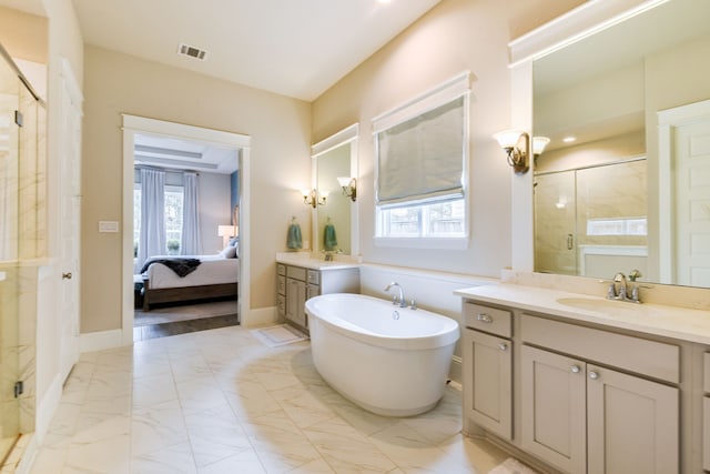 2176 Rope Maker Rd, Conroe, TX 77384 - ensuite bathroom featuring a stall shower, marble look tiles, a freestanding tub, and two vanities
