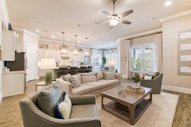 2176 Rope Maker Rd, Conroe, TX 77384 - living room featuring crown molding, a ceiling fan, recessed lighting, light wood-type flooring, and baseboards