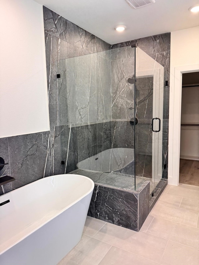 2708 Nagle St, Houston, TX 77004 - full bath with a freestanding tub, a marble finish shower, recessed lighting, and tile walls