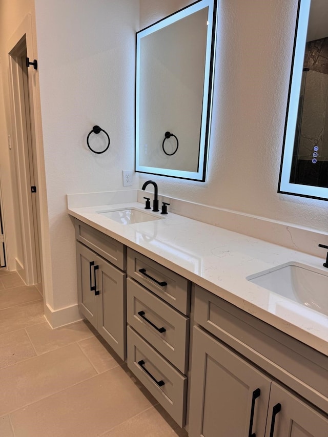 2708 Nagle St, Houston, TX 77004 - bathroom with double vanity, tile patterned flooring, a tile shower, and baseboards