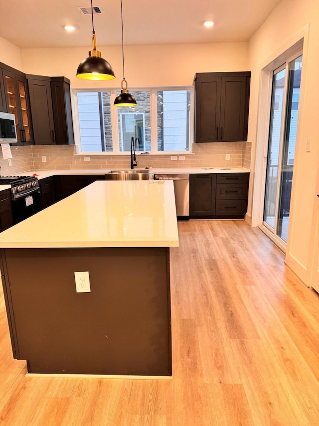 2708 Nagle St, Houston, TX 77004 - kitchen featuring stainless steel appliances, a sink, light countertops, tasteful backsplash, and recessed lighting