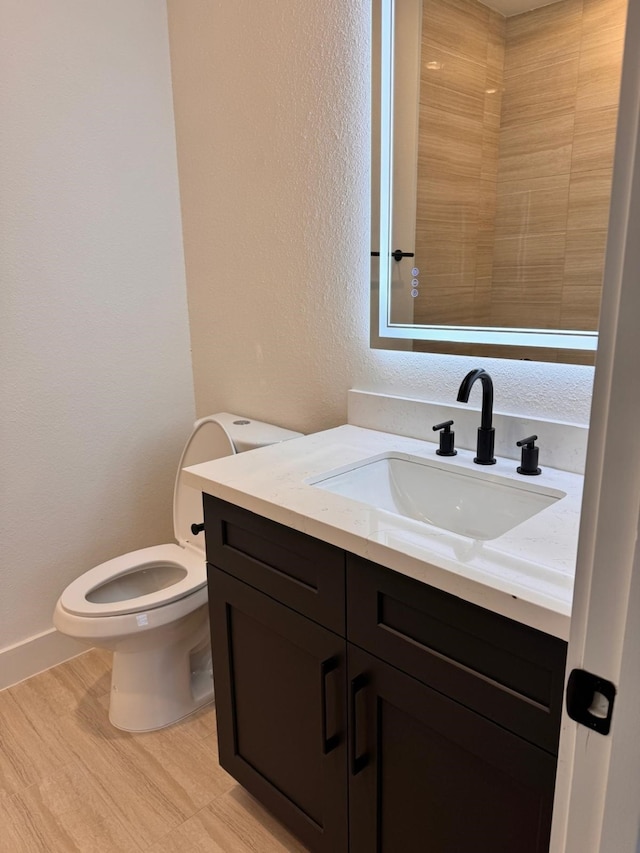 2708 Nagle St, Houston, TX 77004 - bathroom with vanity, toilet, and a textured wall