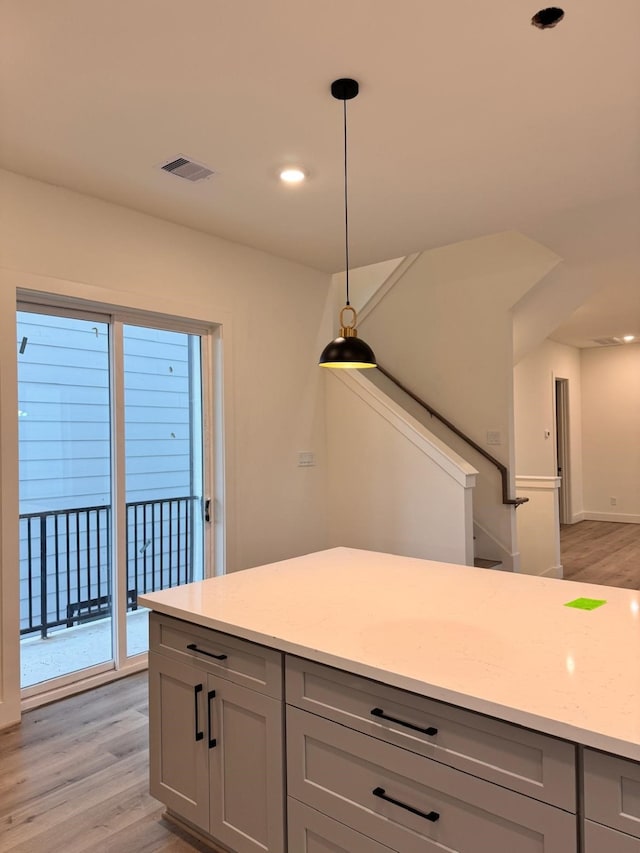 2708 Nagle St, Houston, TX 77004 - kitchen featuring gray cabinets, light wood finished floors, decorative light fixtures, baseboards, and recessed lighting