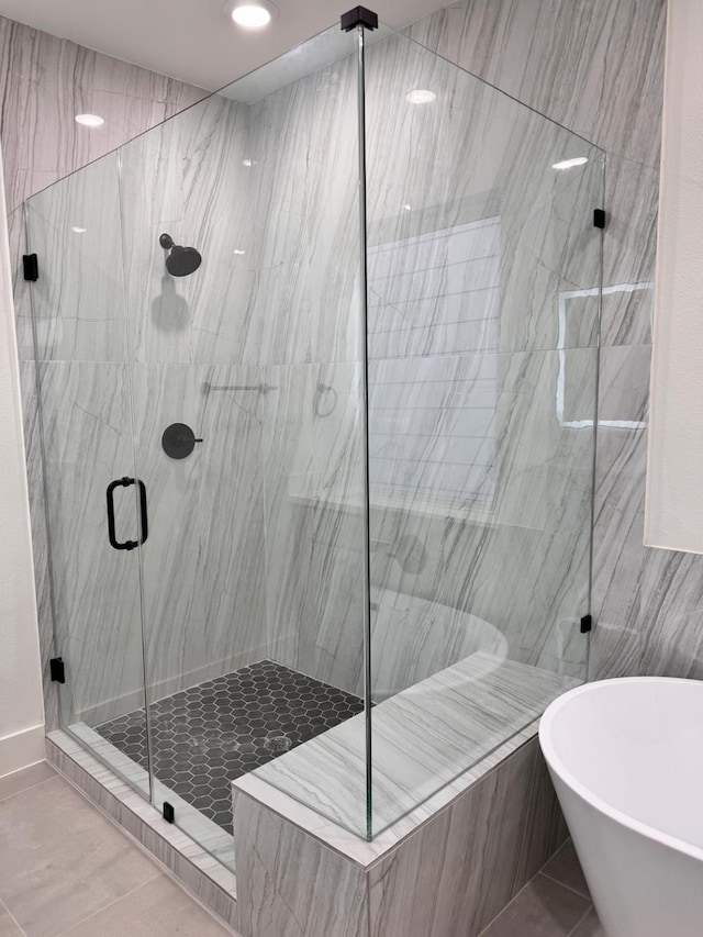 2708 Nagle St, Houston, TX 77004 - bathroom with a marble finish shower, a soaking tub, and tile patterned floors