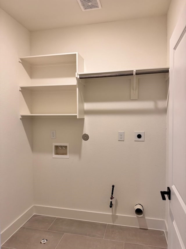 2708 Nagle St, Houston, TX 77004 - laundry area with hookup for an electric dryer, hookup for a washing machine, dark tile patterned flooring, and gas dryer hookup