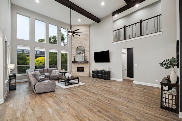 321 Waterford Way, Montgomery, TX 77356 - living room with a towering ceiling, baseboards, beam ceiling, wood finished floors, and a fireplace