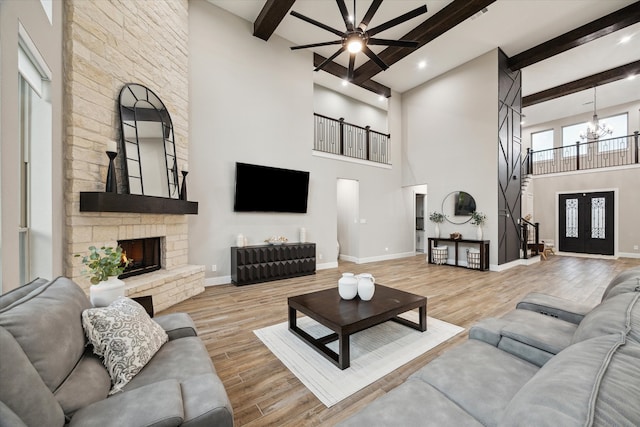 321 Waterford Way, Montgomery, TX 77356 - living room with beamed ceiling, a chandelier, wood finished floors, a high ceiling, and recessed lighting