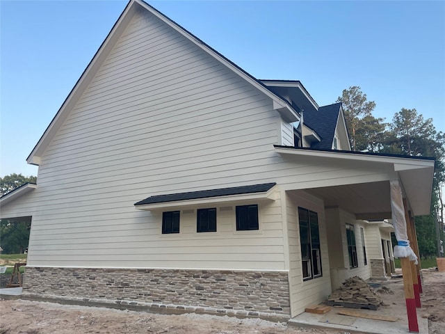 124 Hickory, Village Mills, TX 77663 - view of side of home with stone siding