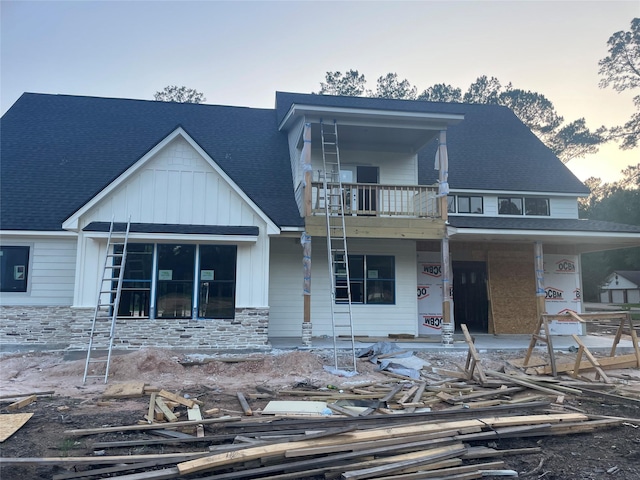 124 Hickory, Village Mills, TX 77663 - view of front of property with a balcony, covered porch, stone siding, and roof with shingles