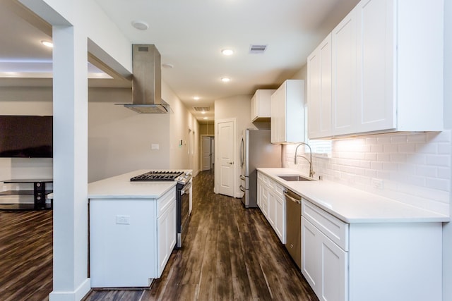 110 Amundsen St, Houston, TX 77009 - kitchen featuring a sink, appliances with stainless steel finishes, dark wood-type flooring, wall chimney exhaust hood, and recessed lighting