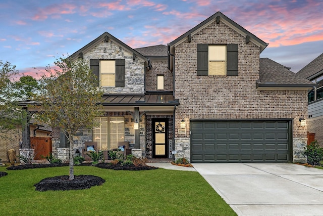 12531 Tullich Run Dr, Humble, TX 77346 - french country inspired facade featuring concrete driveway, a front lawn, a shingled roof, stone siding, and brick siding