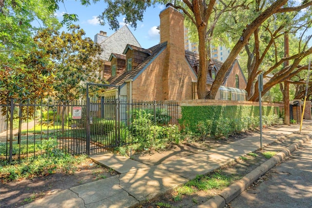 5380 Brownway St Unit D38, Houston, TX 77056 - view of side of property with fence, a gate, a chimney, and brick siding
