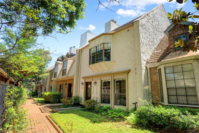 5380 Brownway St Unit D38, Houston, TX 77056 - back of property featuring stucco siding and a chimney