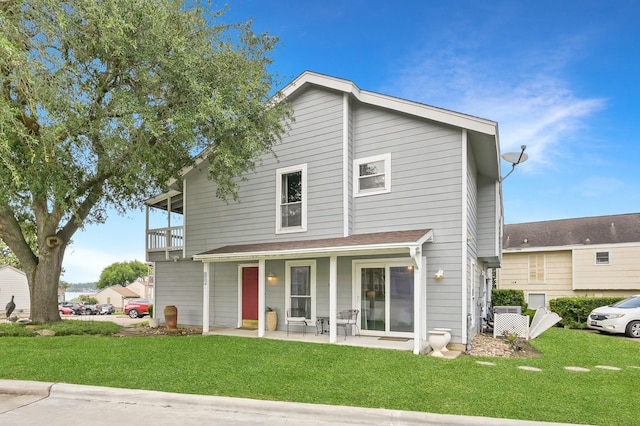 116 April Point Dr N, Conroe, TX 77356 - view of front of home with a front lawn and a balcony