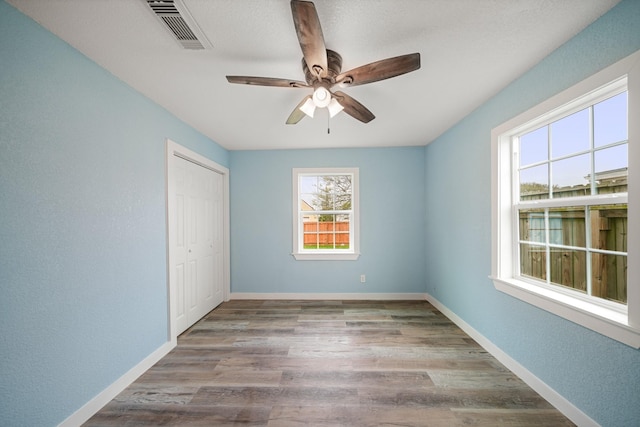 5528 Menard Ave, Galveston, TX 77551 - empty room with a ceiling fan, wood finished floors, and baseboards