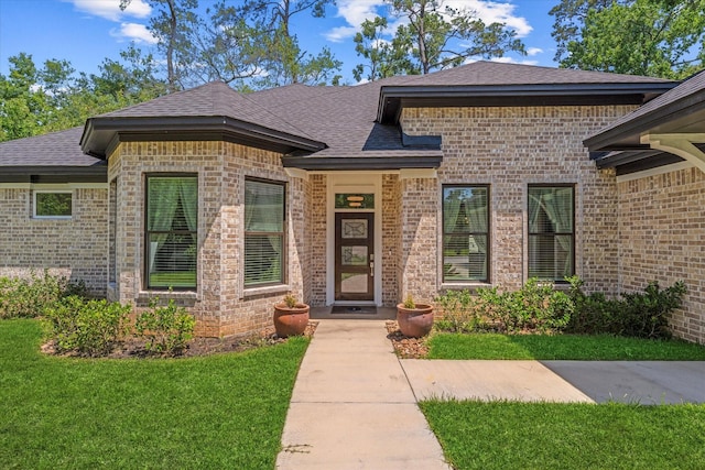 1314 Briar Cliff St, Conroe, TX 77385 - view of front of home featuring brick siding, a front yard, and roof with shingles