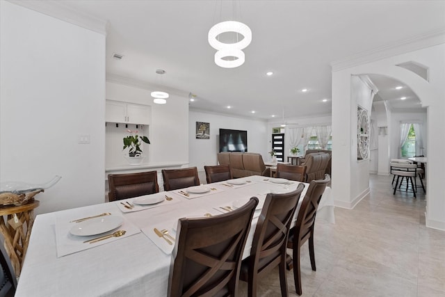 1314 Briar Cliff St, Conroe, TX 77385 - dining area featuring crown molding, arched walkways, recessed lighting, light tile patterned floors, and baseboards