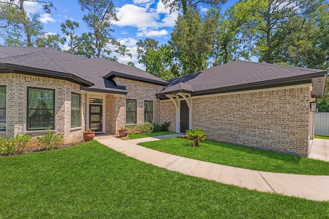 1314 Briar Cliff St, Conroe, TX 77385 - view of front of house featuring a front yard, brick siding, and a shingled roof
