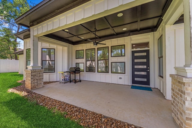 1314 Briar Cliff St, Conroe, TX 77385 - property entrance with board and batten siding, fence, and a patio area