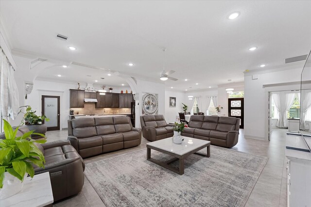 1314 Briar Cliff St, Conroe, TX 77385 - living room featuring recessed lighting, a ceiling fan, ornamental molding, arched walkways, and baseboards