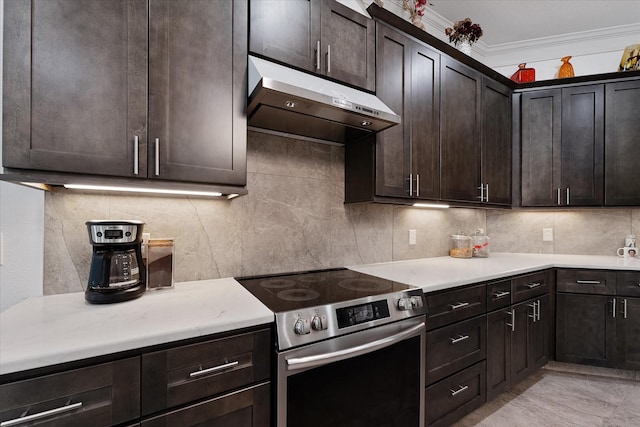 1314 Briar Cliff St, Conroe, TX 77385 - kitchen with electric range, under cabinet range hood, backsplash, light countertops, and ornamental molding