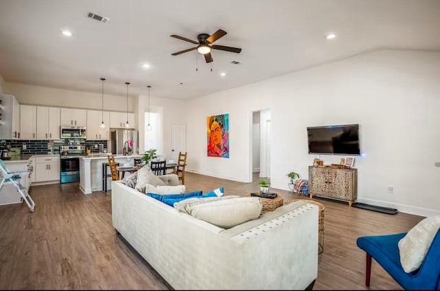 4111 Engelke St, Houston, TX 77003 - living room with a ceiling fan, dark wood finished floors, recessed lighting, and baseboards