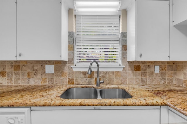5839 Ettrick Dr, Houston, TX 77035 - kitchen with a sink, white cabinets, tasteful backsplash, and light stone counters