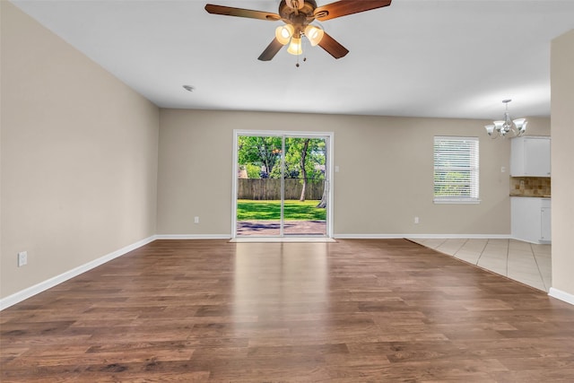 5839 Ettrick Dr, Houston, TX 77035 - unfurnished living room featuring a chandelier, baseboards, ceiling fan, and wood finished floors