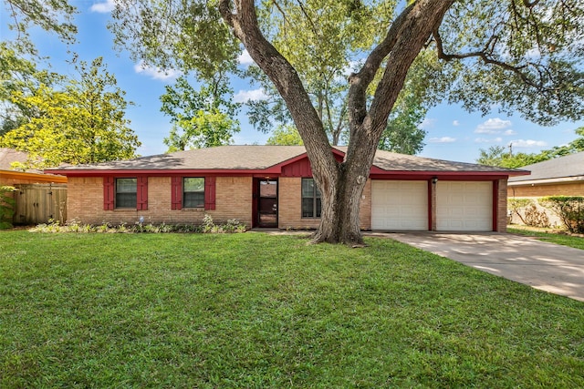 5839 Ettrick Dr, Houston, TX 77035 - view of front facade featuring a garage, concrete driveway, brick siding, and a front yard