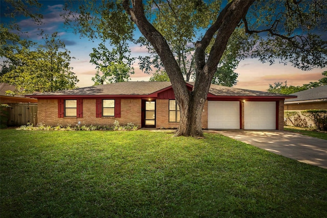 5839 Ettrick Dr, Houston, TX 77035 - view of front facade with a garage, concrete driveway, brick siding, and a front lawn