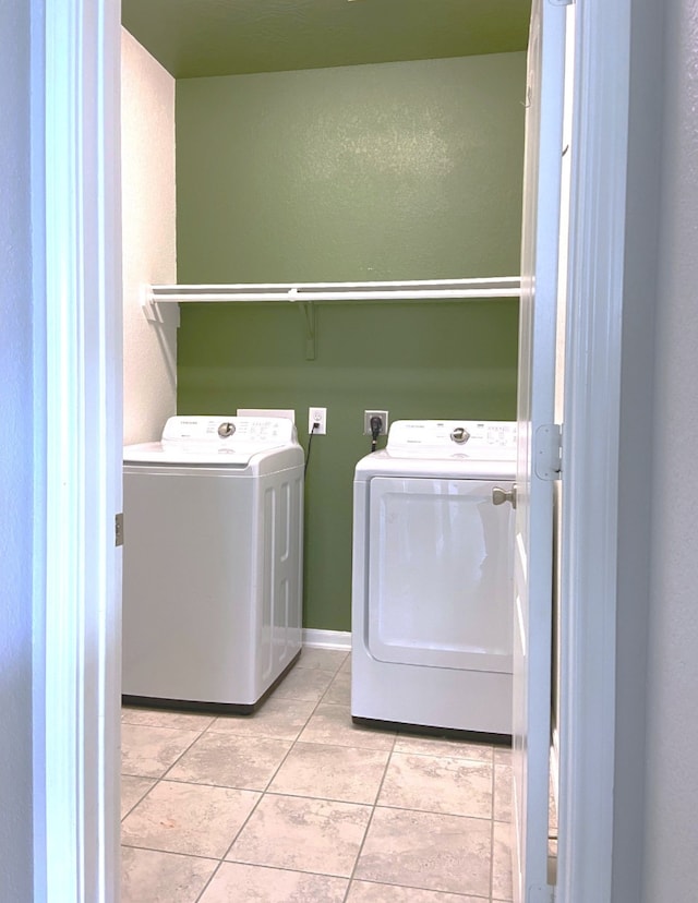 3812 Cimarron Gap Ln, Magnolia, TX 77354 - laundry area featuring washing machine and clothes dryer and light tile patterned flooring