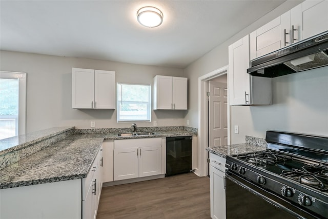801 S Travis Ave, Cleveland, TX 77327 - kitchen featuring black appliances, under cabinet range hood, a sink, wood finished floors, and white cabinetry