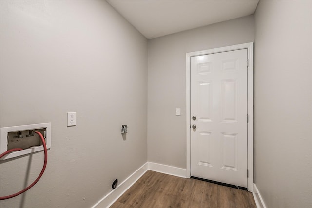 801 S Travis Ave, Cleveland, TX 77327 - clothes washing area with washer hookup, wood finished floors, and baseboards