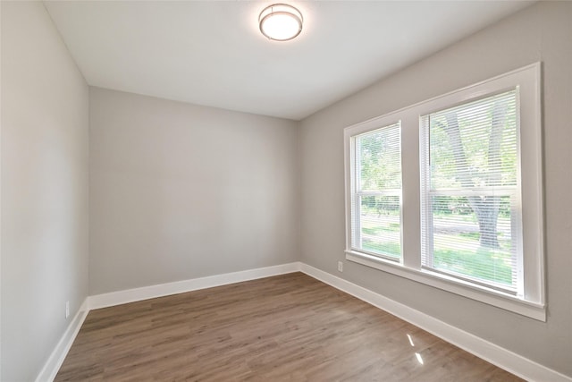 801 S Travis Ave, Cleveland, TX 77327 - unfurnished room featuring wood finished floors and baseboards