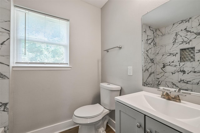 801 S Travis Ave, Cleveland, TX 77327 - bathroom featuring vanity, toilet, and baseboards