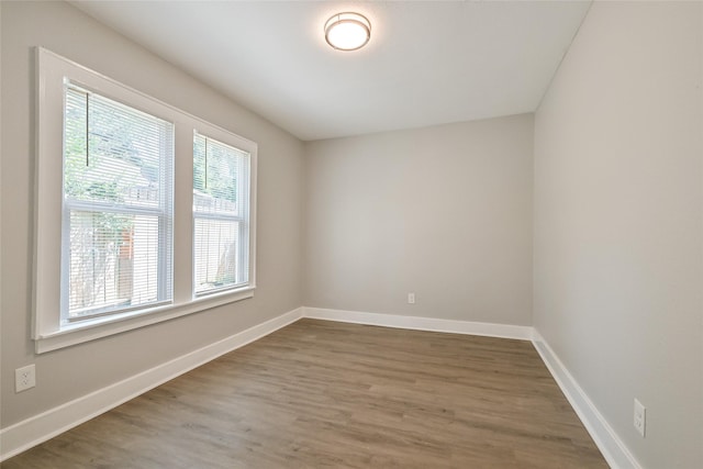 801 S Travis Ave, Cleveland, TX 77327 - spare room featuring wood finished floors and baseboards