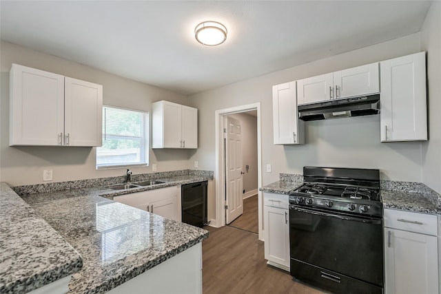 801 S Travis Ave, Cleveland, TX 77327 - kitchen with black appliances, under cabinet range hood, a sink, wood finished floors, and white cabinetry