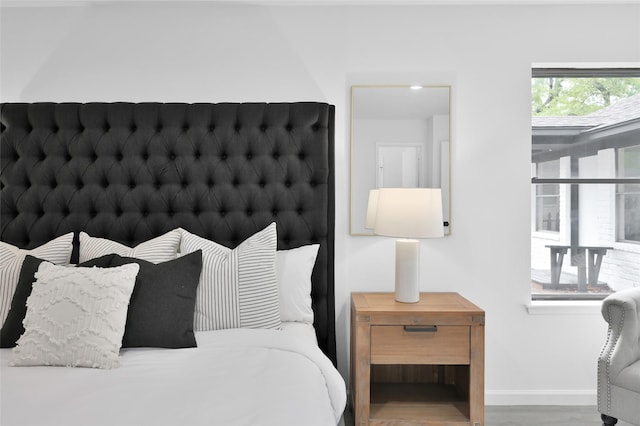 bedroom featuring wood finished floors and baseboards