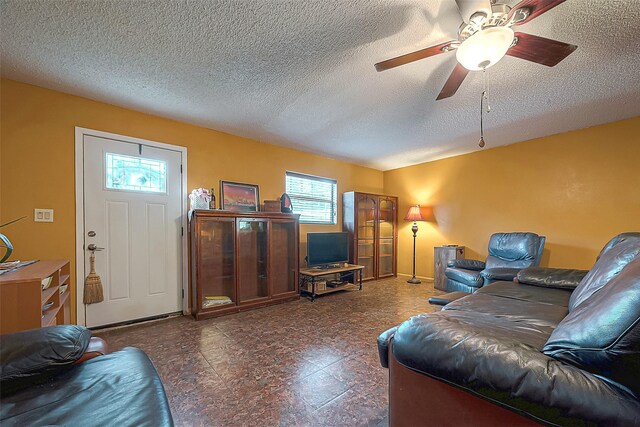 220 Hillcrest Dr, Coldspring, TX 77331 - living area featuring ceiling fan, a textured ceiling, and tile patterned floors