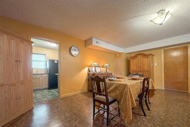 220 Hillcrest Dr, Coldspring, TX 77331 - dining room featuring a textured ceiling and baseboards