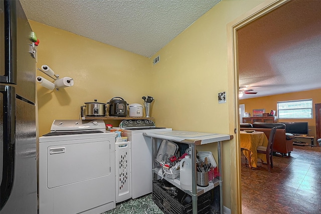 220 Hillcrest Dr, Coldspring, TX 77331 - laundry room featuring a textured ceiling, washer and dryer, a ceiling fan, and tile patterned floors