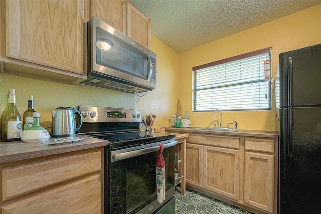 220 Hillcrest Dr, Coldspring, TX 77331 - kitchen with appliances with stainless steel finishes, a sink, light brown cabinets, and a textured ceiling