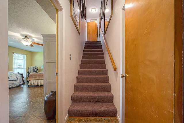 220 Hillcrest Dr, Coldspring, TX 77331 - staircase with a textured ceiling and ceiling fan