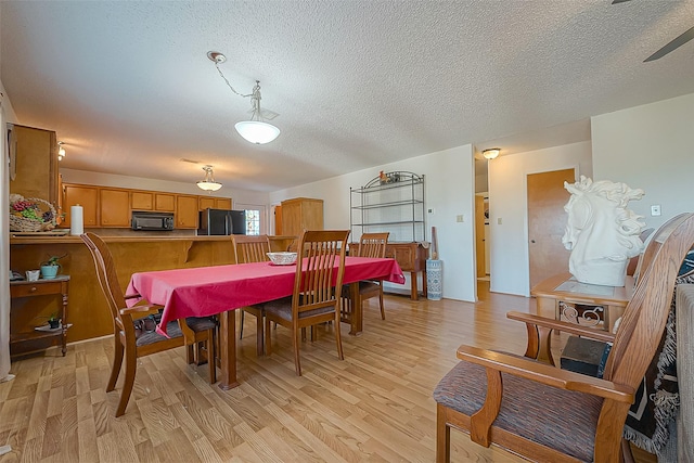 220 Hillcrest Dr, Coldspring, TX 77331 - dining area featuring light wood finished floors, a textured ceiling, and ceiling fan